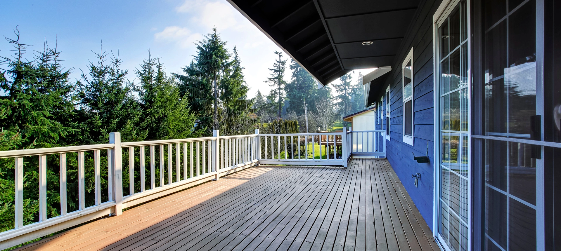 Spacious wooden deck with forest view