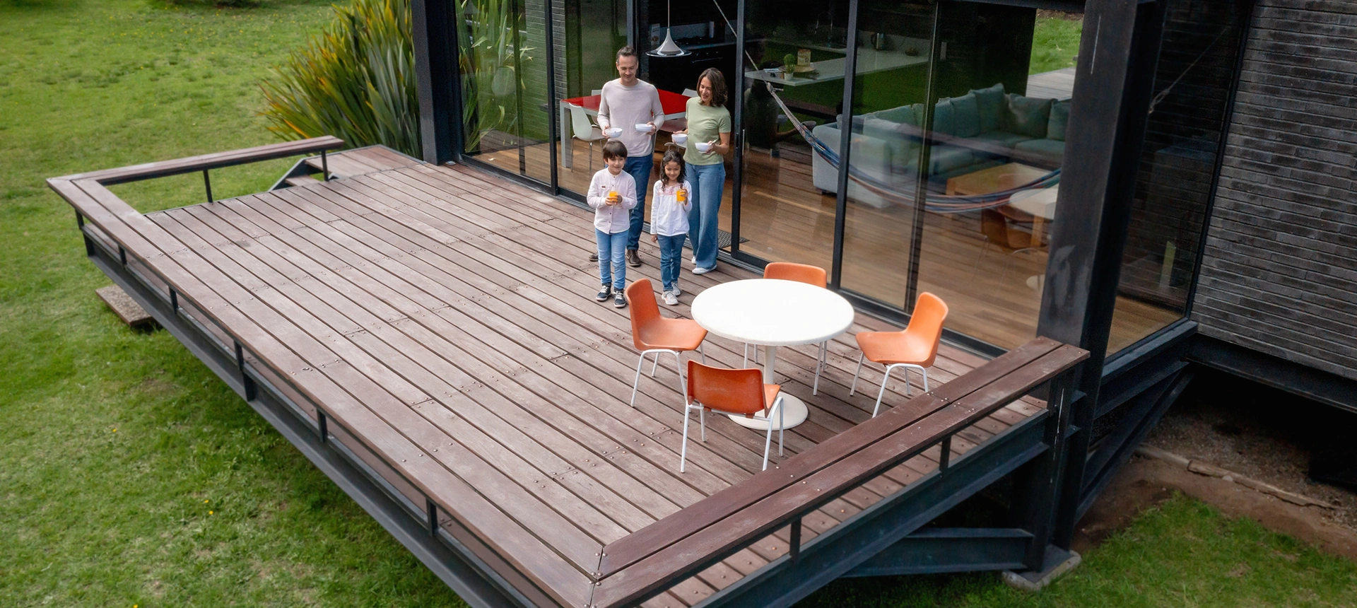 Family standing on wooden patio