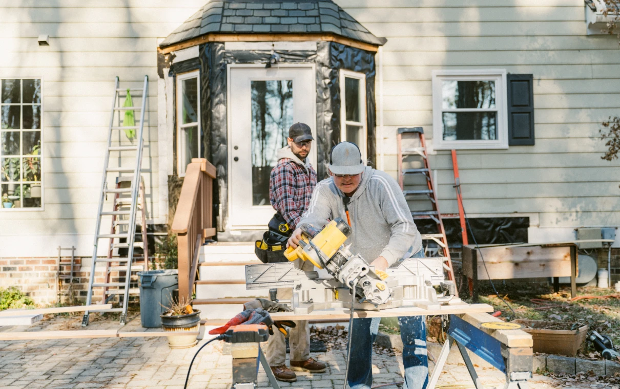 House exterior with builders and tools