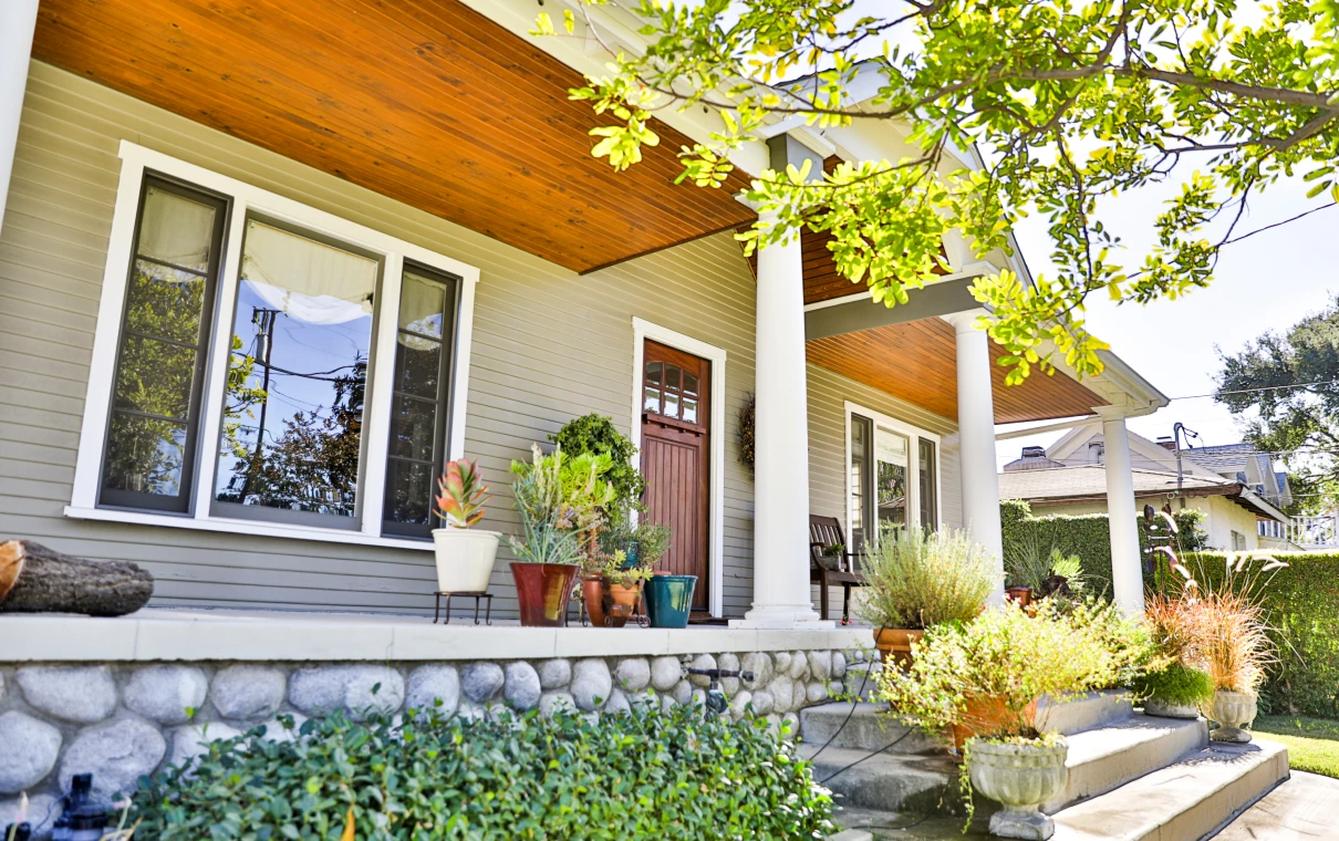 Cozy front porch with potted plants
